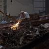 A worker at the site of the World Trade Center bombing welds through steel to clear rubble in the ongoing clean up effort.